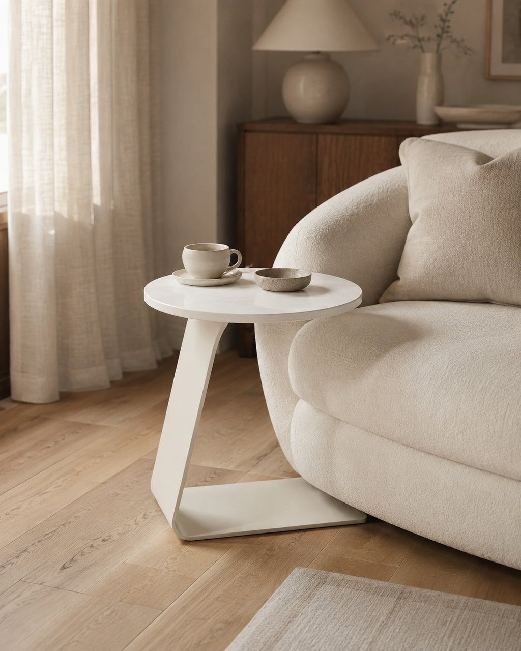 Solid White Sintered Stone Modern C-Shaped Side Table beside an armchair